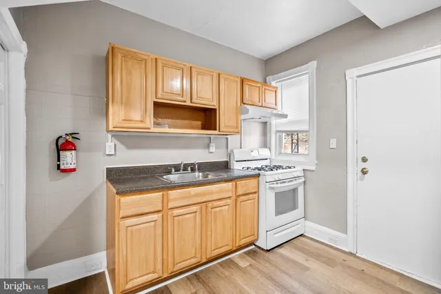 a kitchen with stainless steel appliances granite countertop a sink and cabinets