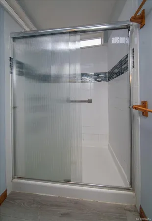 a bathroom with a glass shower door