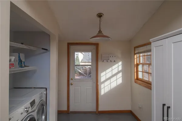 a view of a hallway to a livingroom with furniture