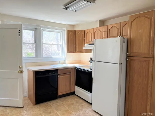 a white refrigerator freezer and a stove top oven in a kitchen