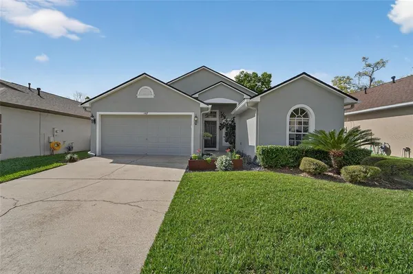a front view of a house with a yard and garage