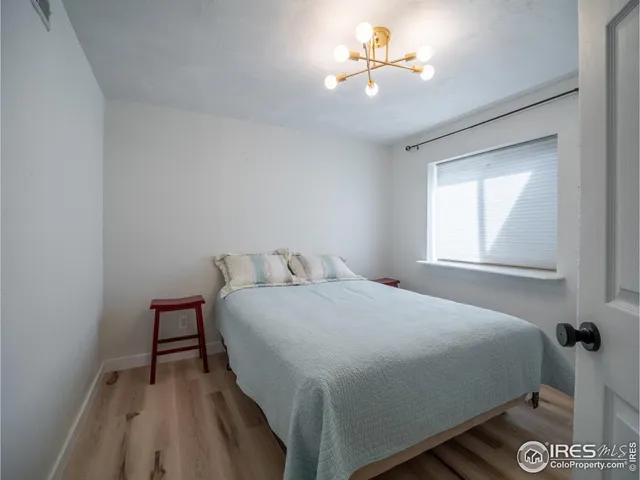 a view of a room with furniture and wooden floor