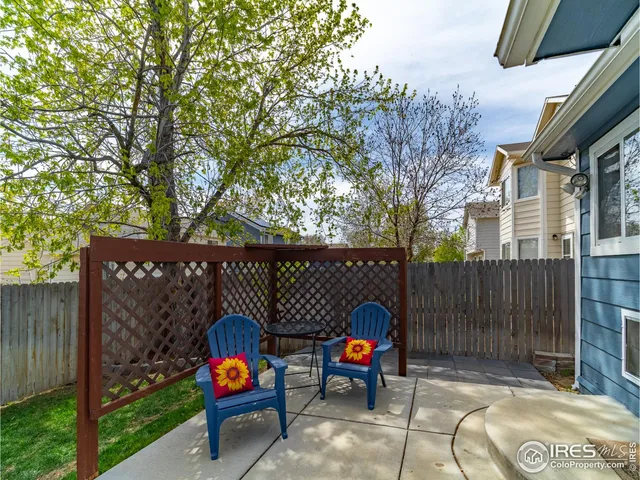a view of a chairs and table in backyard of the house