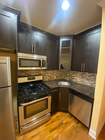 a kitchen with stainless steel appliances granite countertop a stove and a sink