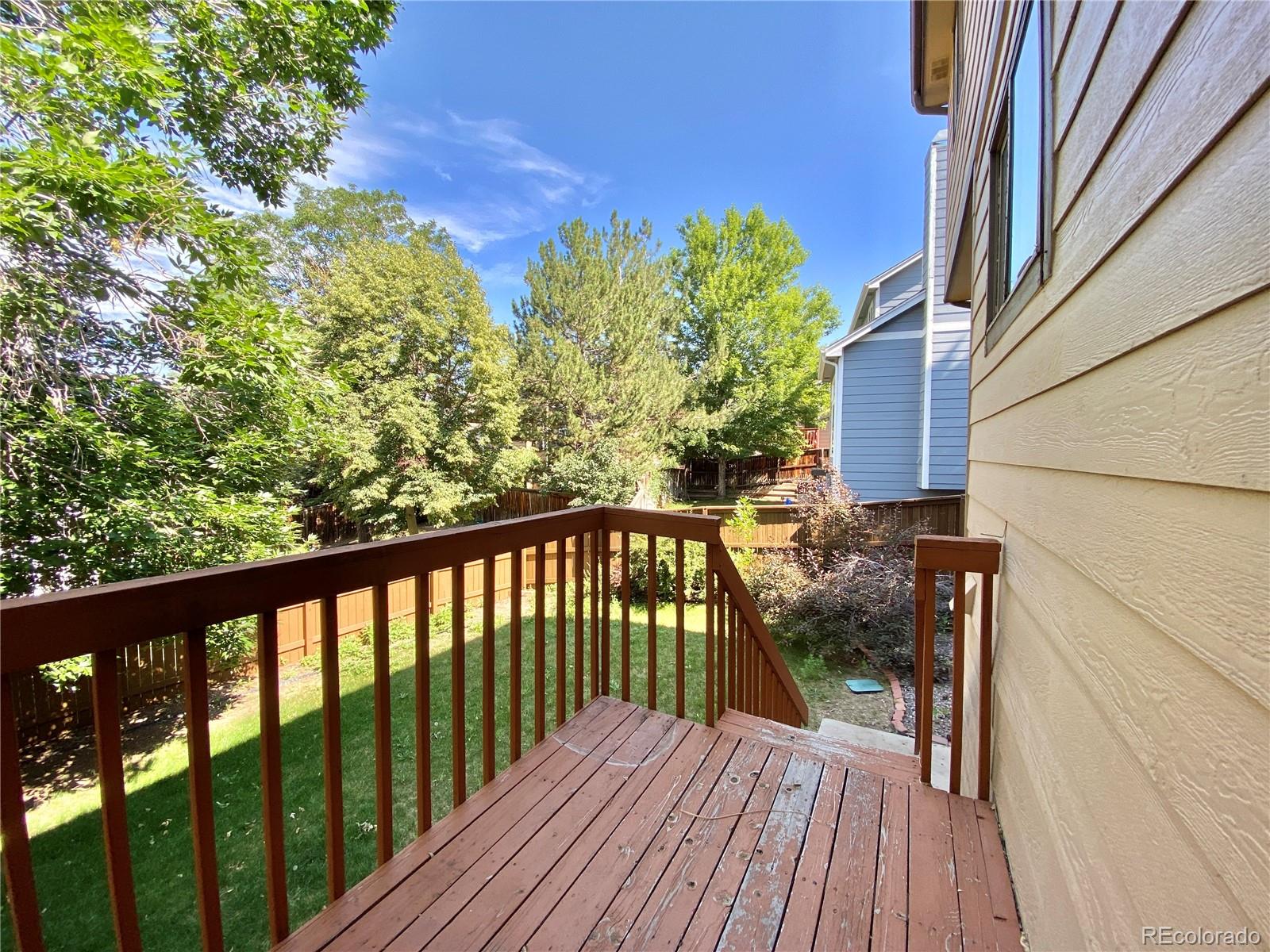 9393 Princeton Street Highlands Ranch, CO 80130 - Photo 17 of 18 a view of balcony with wooden floor and fence