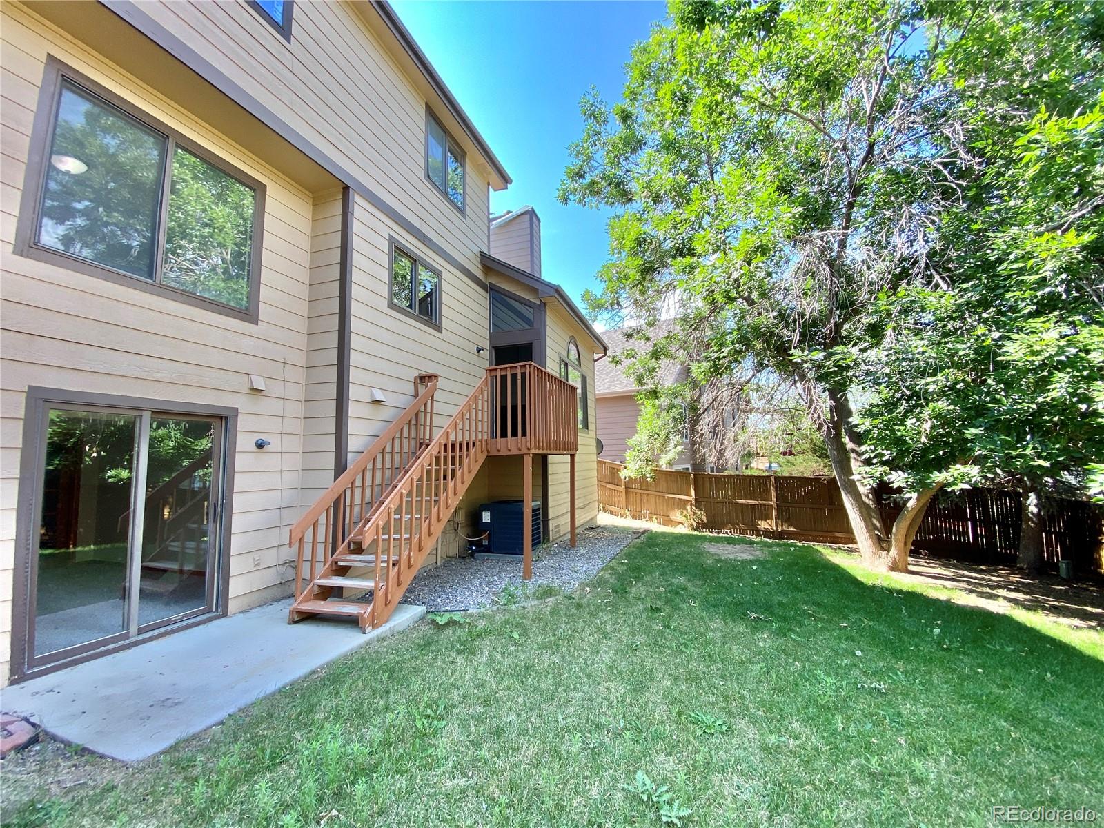 9393 Princeton Street Highlands Ranch, CO 80130 - Photo 18 of 18 a view of backyard with a table and chairs