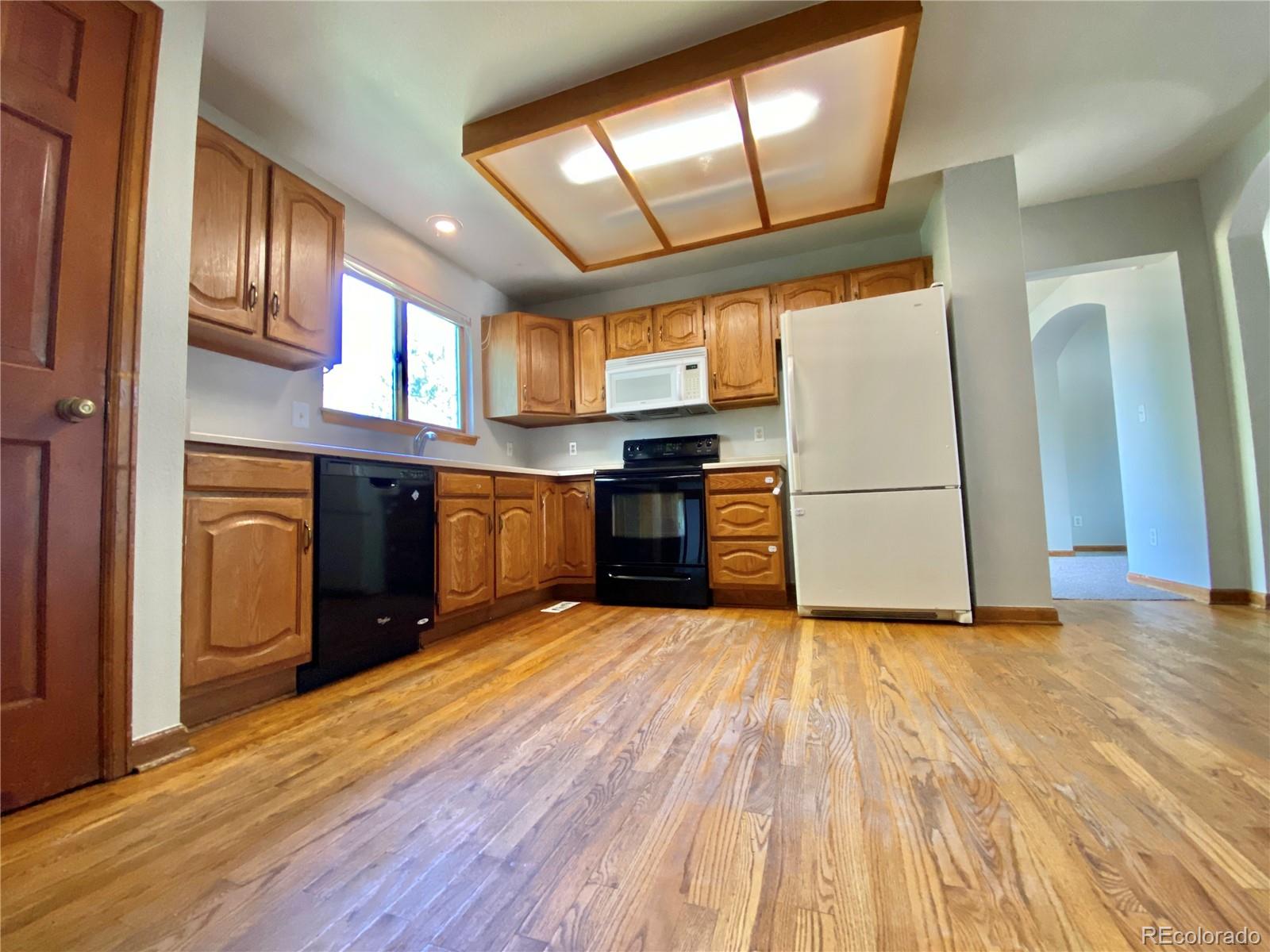 9393 Princeton Street Highlands Ranch, CO 80130 - Photo 2 of 18 a view of a kitchen with a sink cabinets and a window