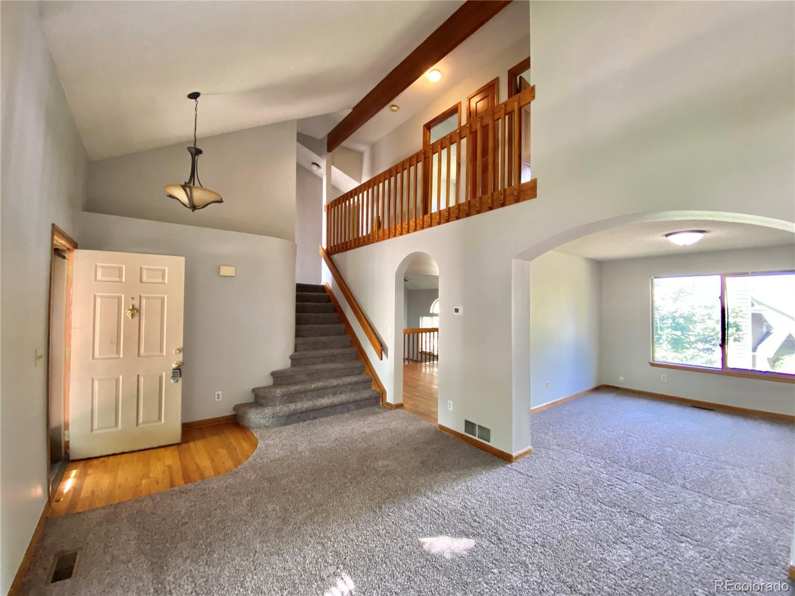 9393 Princeton Street Highlands Ranch, CO 80130 - Photo 4 of 18 wooden floor in an empty room with a window