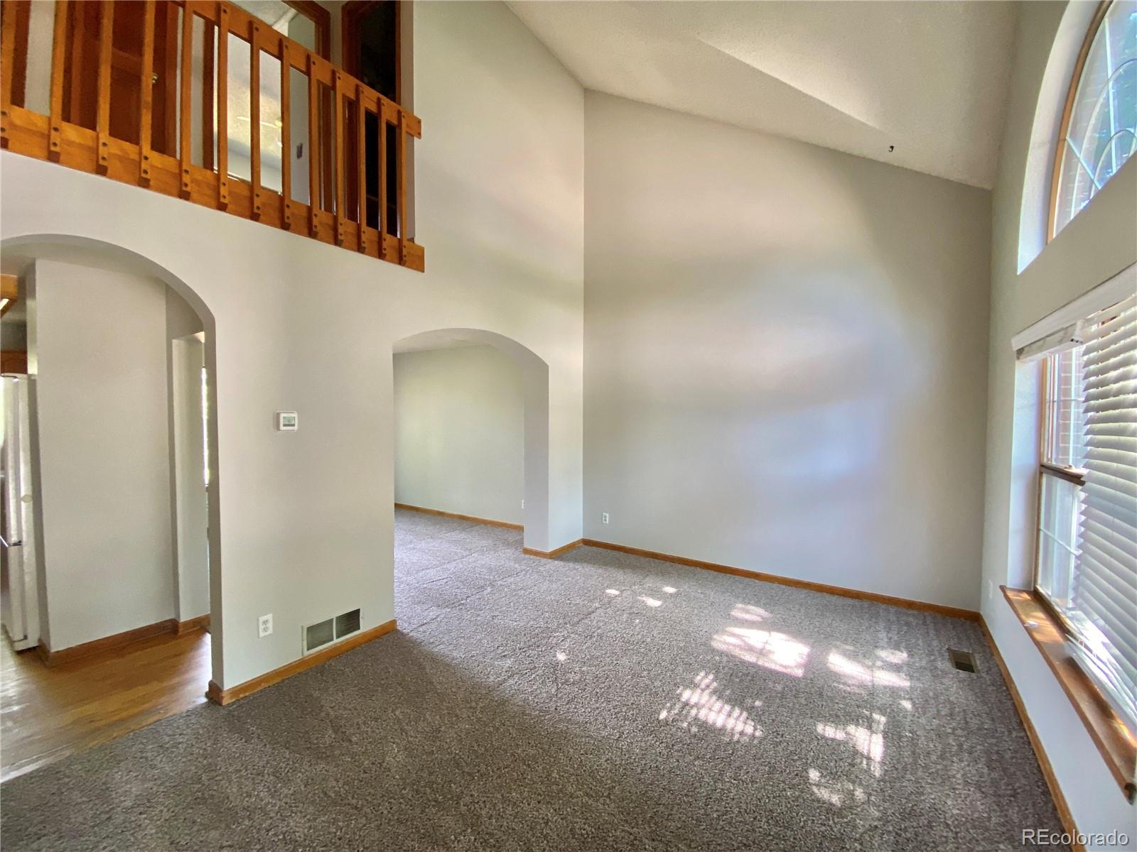 9393 Princeton Street Highlands Ranch, CO 80130 - Photo 5 of 18 an empty room with windows