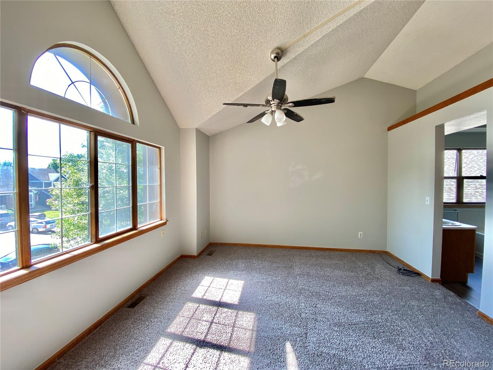 9393 Princeton Street Highlands Ranch, CO 80130 - Photo 9 of 18 wooden floor in an empty room with a window