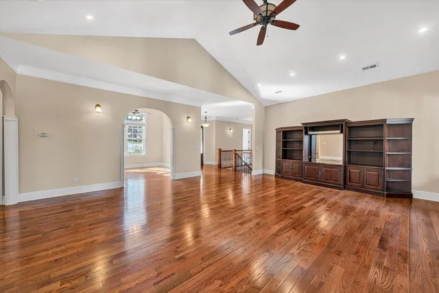 a kitchen with stainless steel appliances granite countertop a stove a sink and a granite counter tops with white cabinets