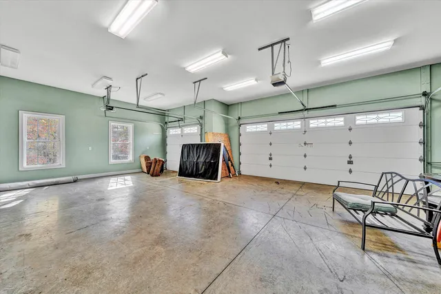 an empty room with wooden floor a ceiling fan and windows