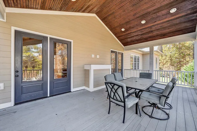 a view of a livingroom with wooden floor and a staircase