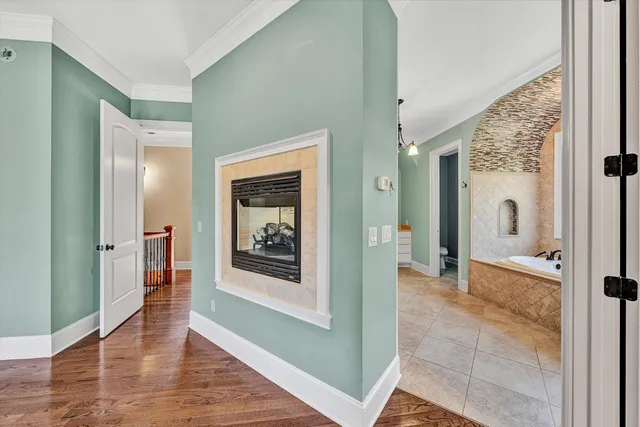 a spacious bedroom with a bed and a flat screen tv