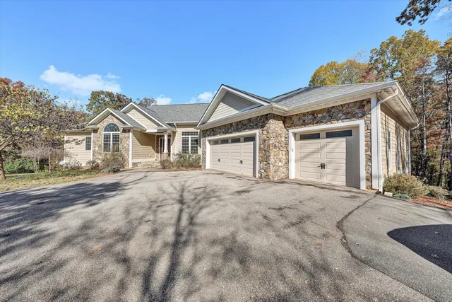 a view of empty room with wooden floor and window