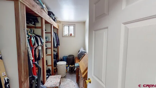 a view of walk in closet with clothes