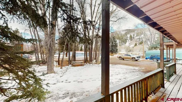 a view of a snow on the road from a balcony