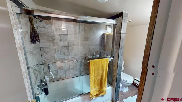 a bathroom with a tub and toilet
