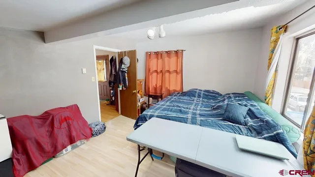 a living room with a bed furniture and a window