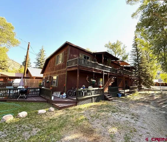 a view of a house with swimming pool and sitting area