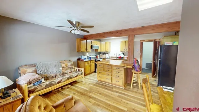 a living room with furniture appliances and a dining table