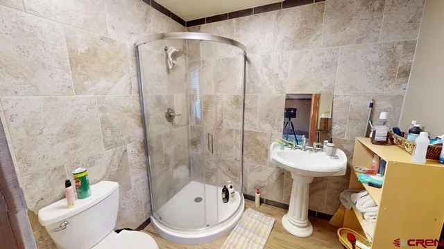 a bathroom with a sink toilet and shower