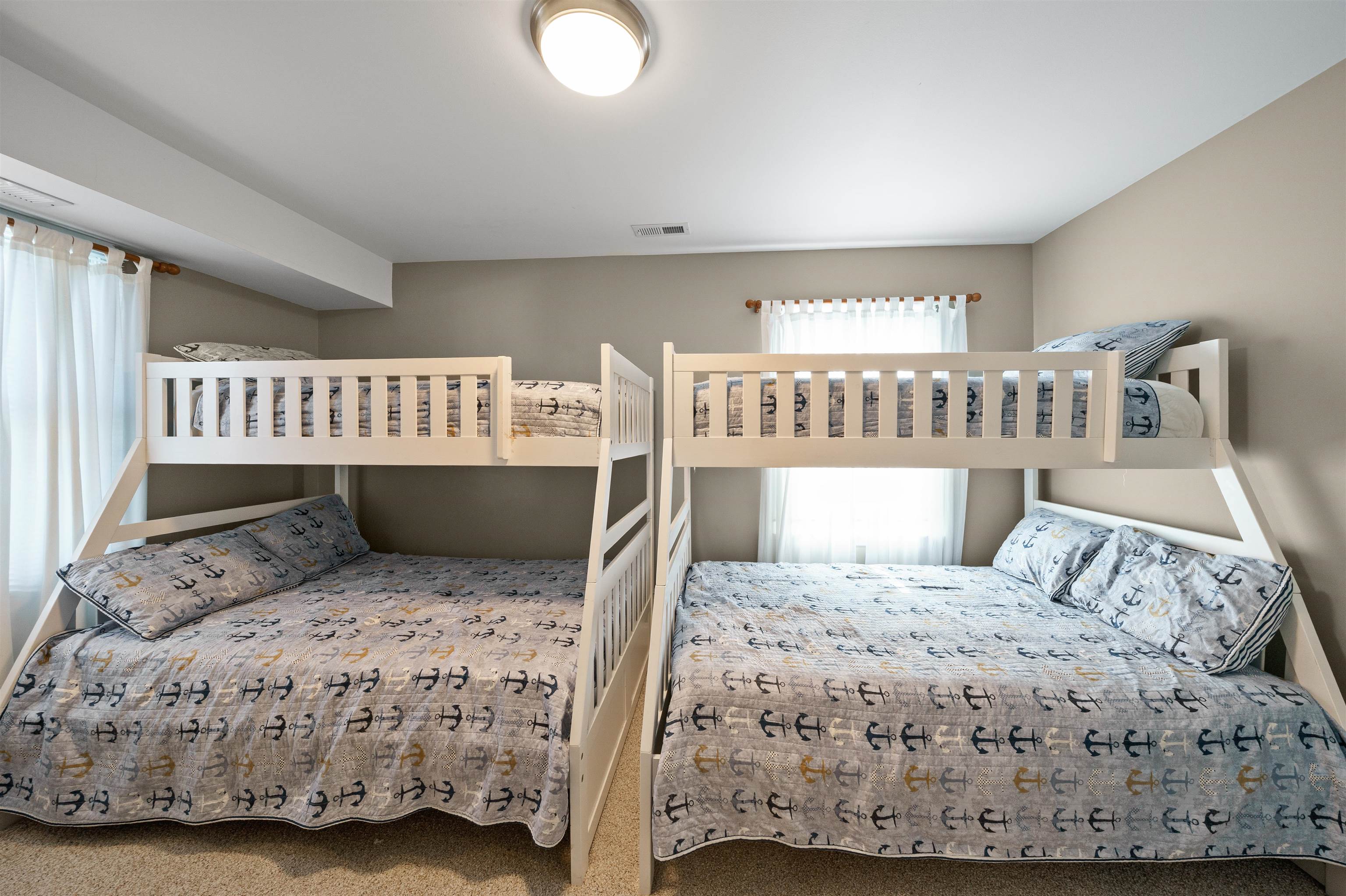 212 25th Street, Unit END Avalon, NJ 08202 - Photo 17 of 34 a bedroom with a bed and wooden floor