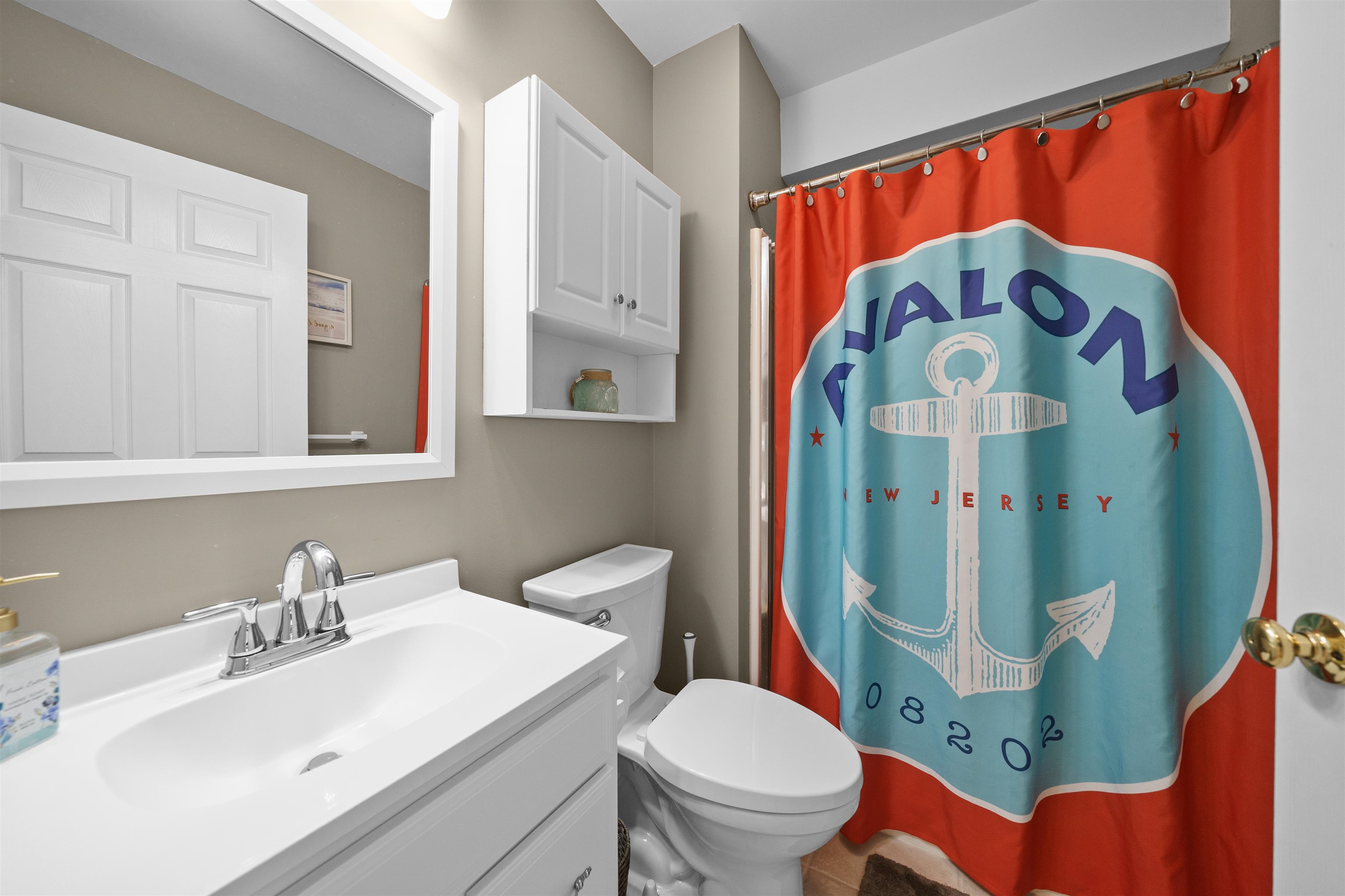 212 25th Street, Unit END Avalon, NJ 08202 - Photo 21 of 34 a bathroom with a sink mirror vanity and toilet