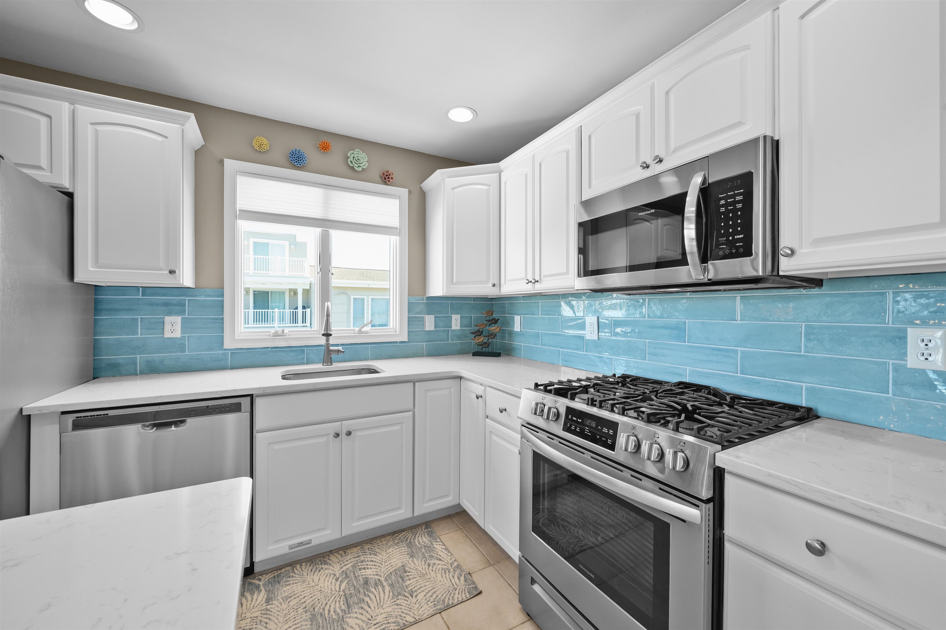 212 25th Street, Unit END Avalon, NJ 08202 - Photo 7 of 34 a kitchen with cabinets appliances a sink and a window