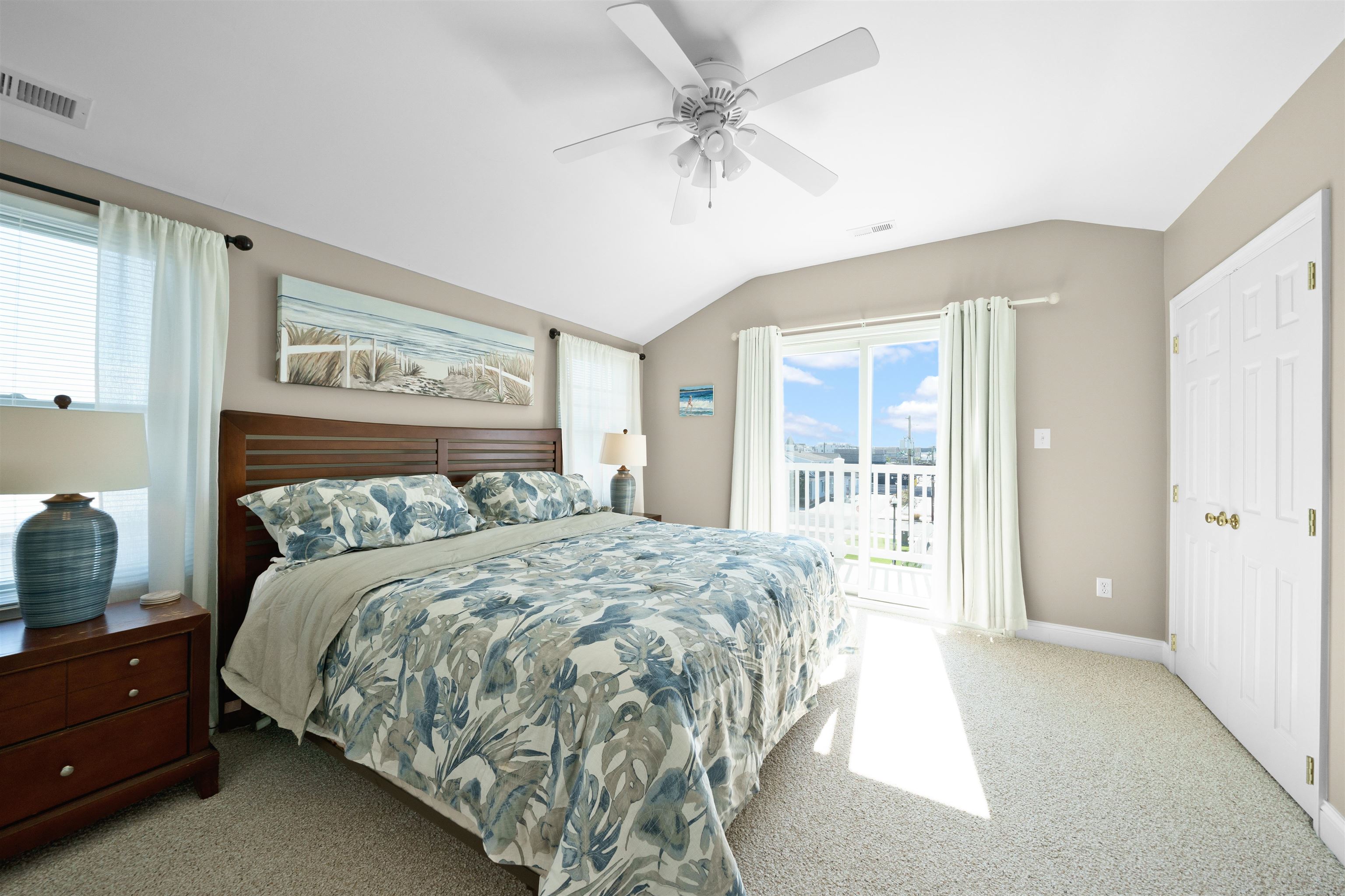 212 25th Street, Unit END Avalon, NJ 08202 - Photo 9 of 34 a spacious bedroom with a large bed and a chandelier