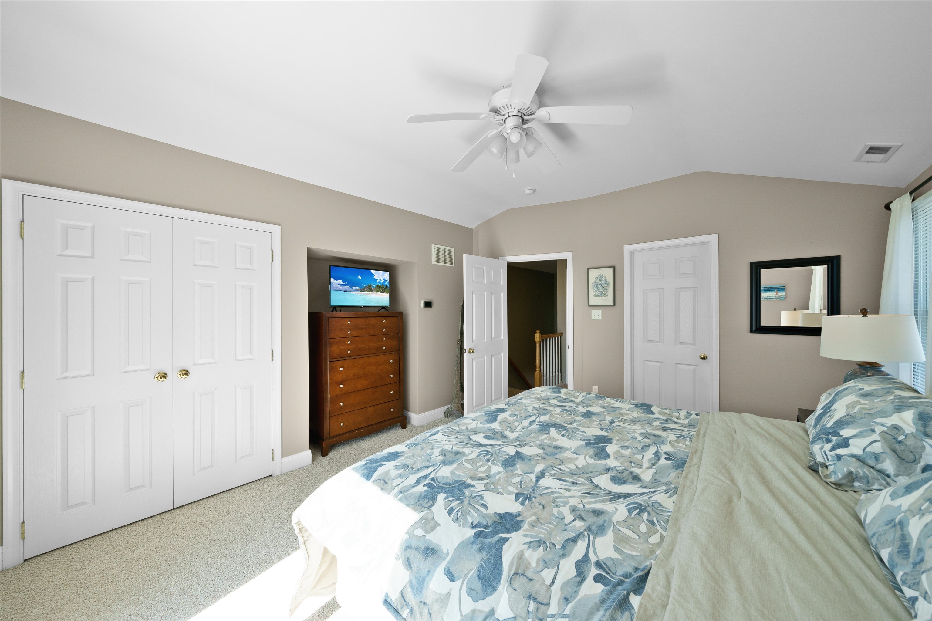 212 25th Street, Unit END Avalon, NJ 08202 - Photo 10 of 34 a bedroom with a bed and a chandelier