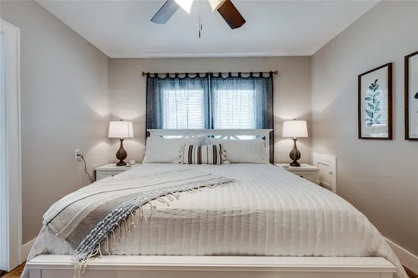 a spacious bedroom with a bed and a dresser