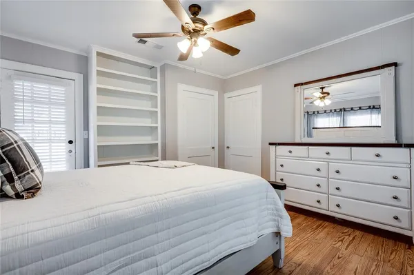 a bedroom with a large bed and a chandelier