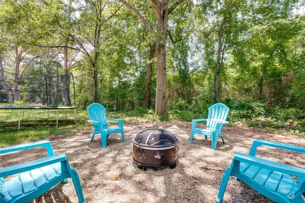 a view of a backyard with sitting area and fire pit