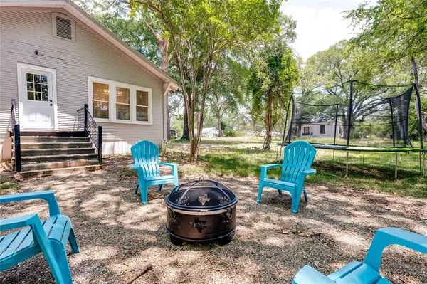 a view of a house with backyard and sitting area