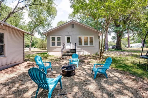 a view of a house with backyard and sitting area