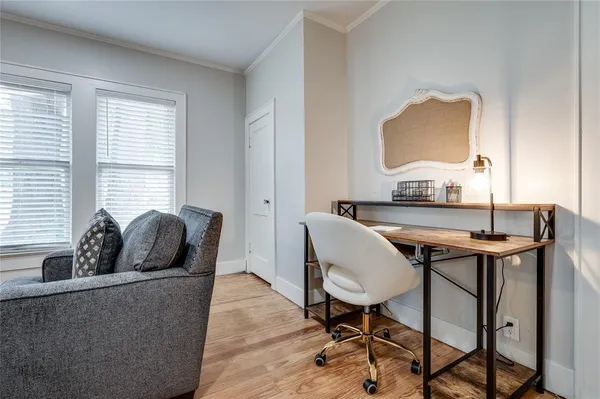 a kitchen with a refrigerator and white cabinets