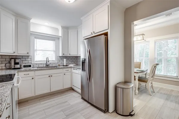 a kitchen with stainless steel appliances granite countertop a sink and cabinets