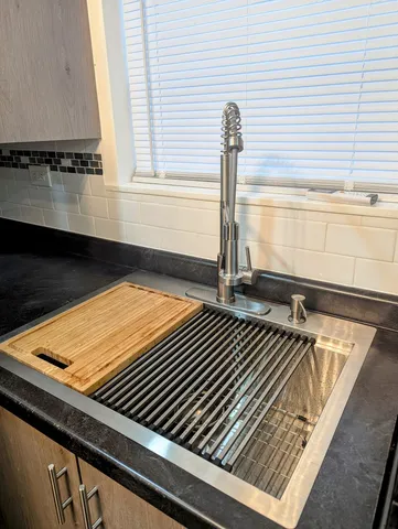 a close view of a sink and dishwasher