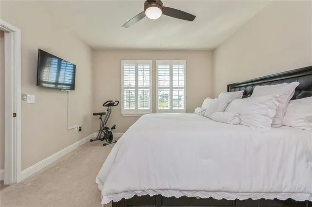 a spacious bedroom with a bed and a flat screen tv