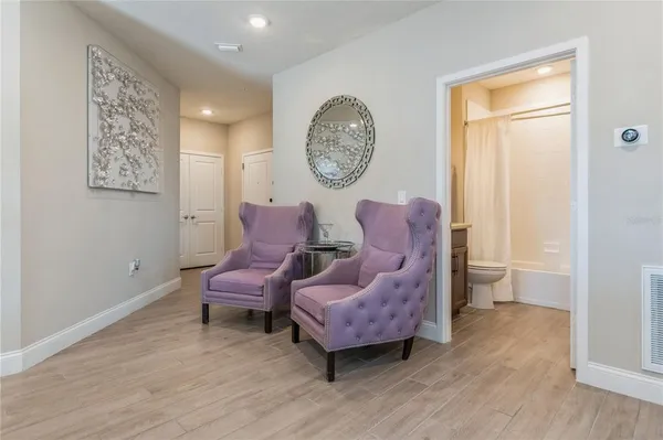 a living room with furniture and a wooden floor
