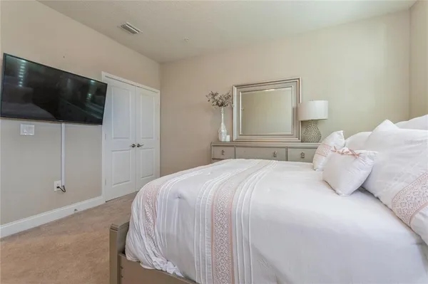 a bedroom with a bed and a flat screen tv