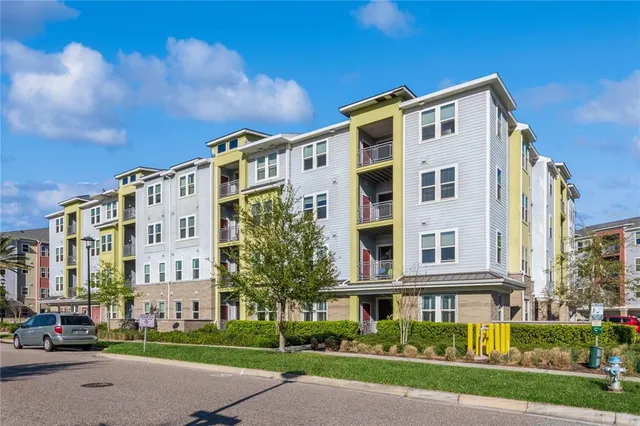 a front view of a building with a garden