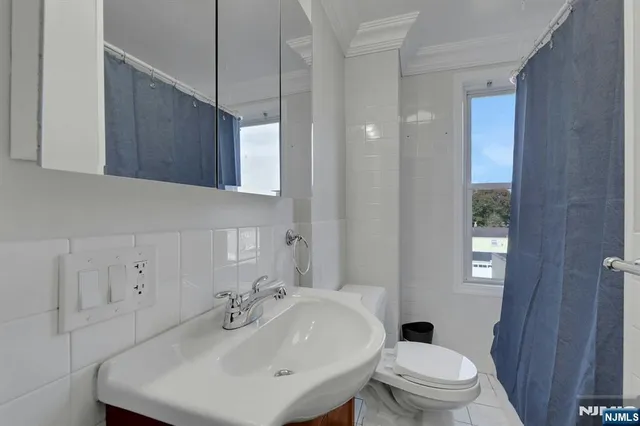 a bathroom with a sink toilet and mirror