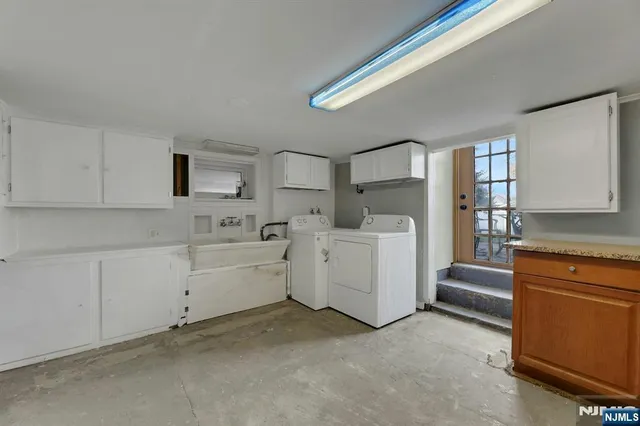 a kitchen with white cabinets and white appliances