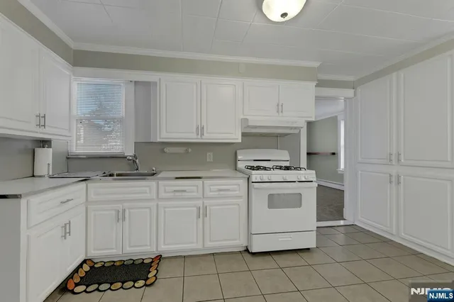 a kitchen with cabinets appliances and a window