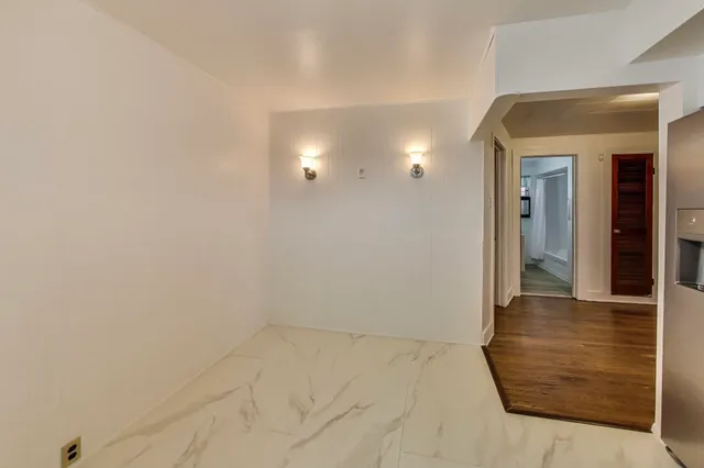 a view of a room with wooden floor