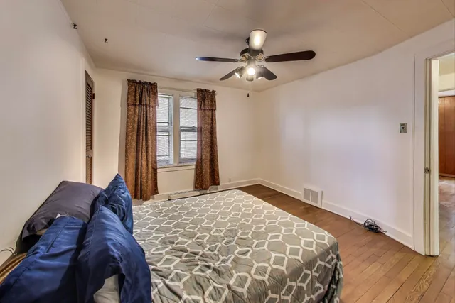 a bedroom with a large bed and a window