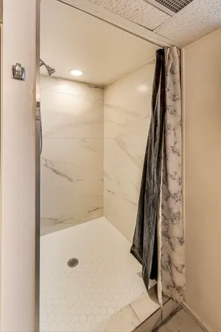 a bathroom with a shower and a glass door