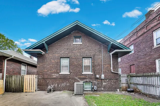 a front view of a house with iron fence